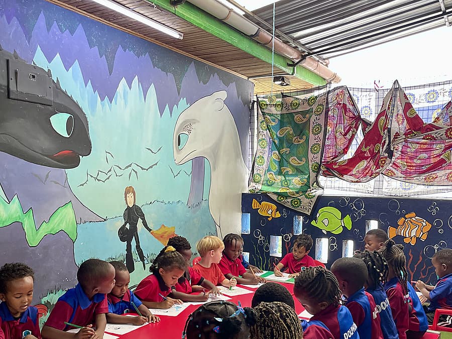 Children writing stories during a creative writing workshop